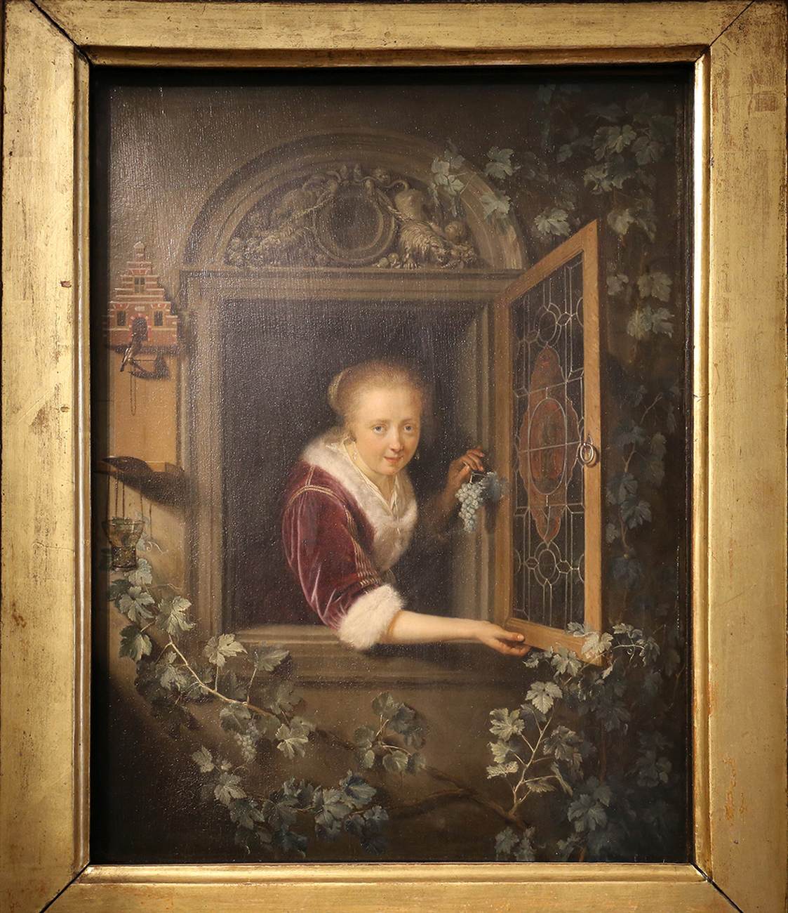 Young Woman at the Window with a Bunch of Grapes